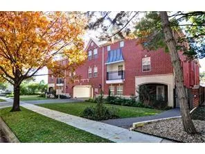 a front view of a house with a garden and tree