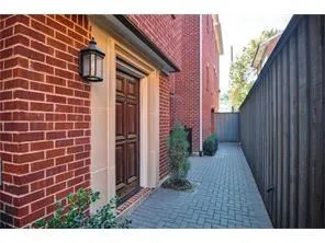 a view of a house with brick walls