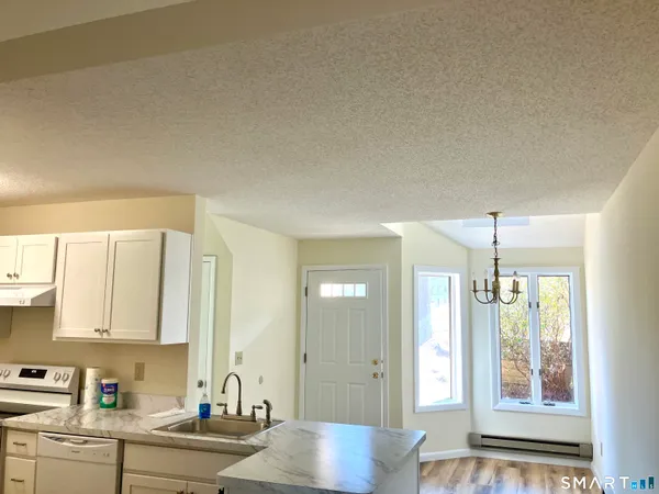 a kitchen with a window appliances and cabinets