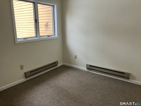 an empty room with wooden floor