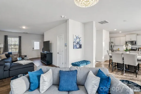 a living room with furniture a flat screen tv and a window