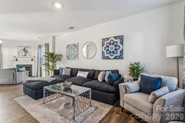 a living room with furniture and wooden floor