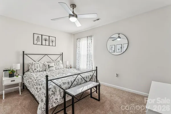 a bedroom with a bed and a lamp on table