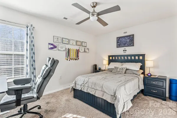 a bedroom with a bed and a chair