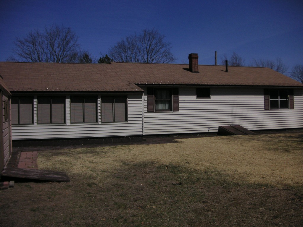 20 Natchez Street Lowell, MA 01850 - Photo 2 of 14 a front view of a house with a yard