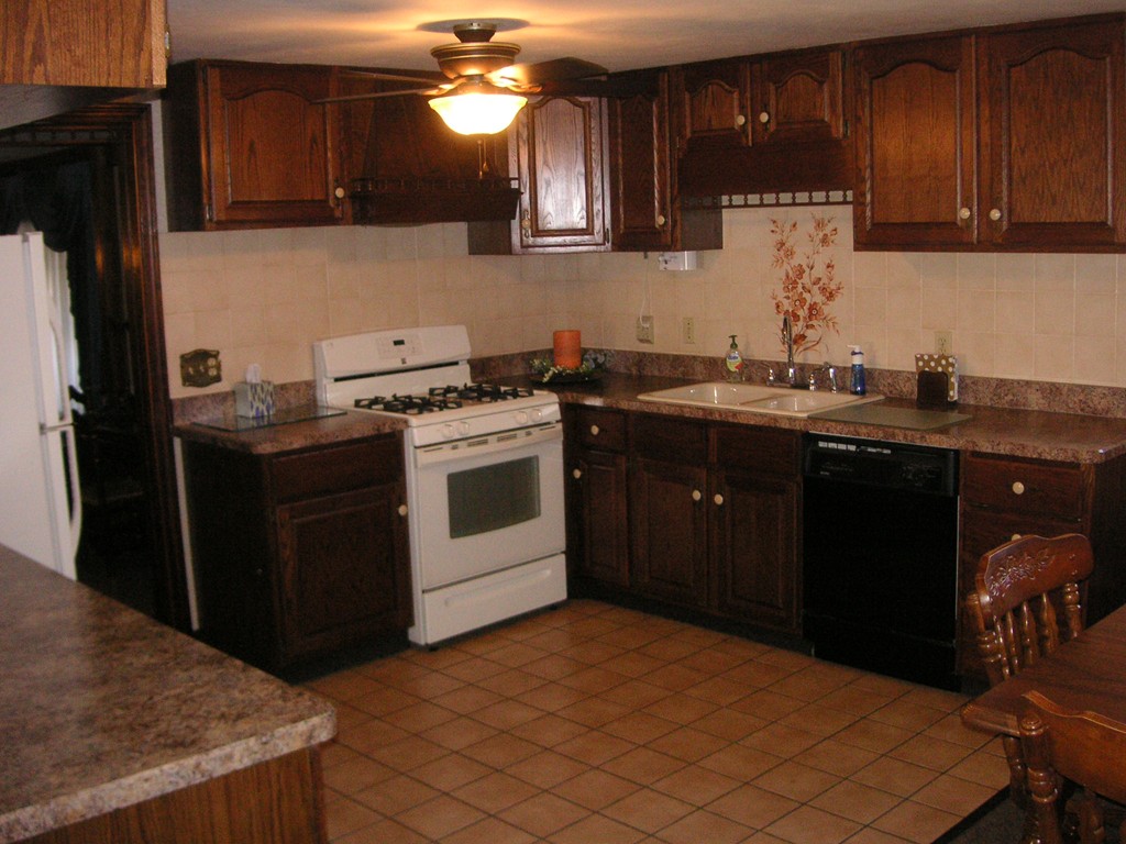 20 Natchez Street Lowell, MA 01850 - Photo 4 of 14 a kitchen with stainless steel appliances granite countertop a sink a stove a refrigerator and cabinets