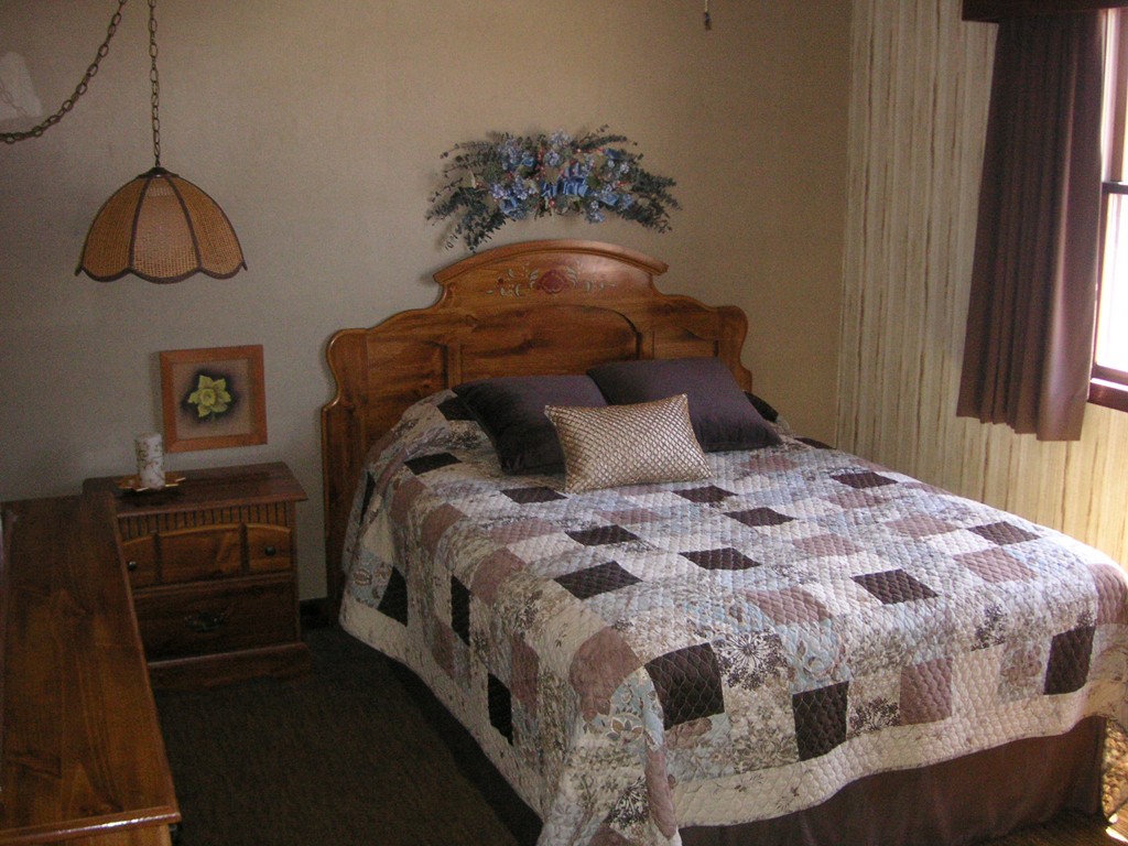 20 Natchez Street Lowell, MA 01850 - Photo 6 of 14 a bedroom with a bed and dresser with wooden floor