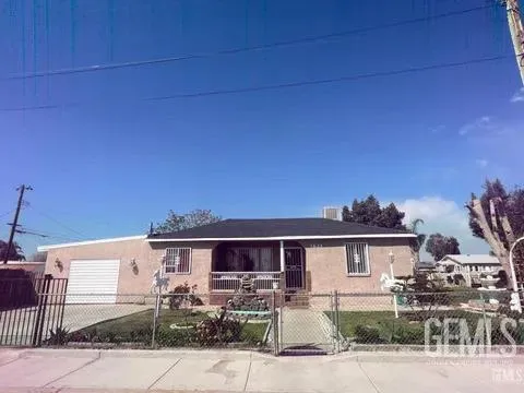 a front view of a house with yard and outdoor seating