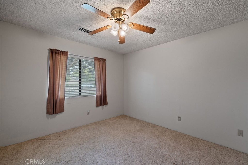 2065 Jenkins Road Bakersfield, CA 93314 - Photo 27 of 59 an empty room with windows and fan