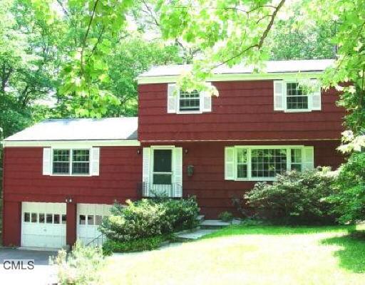63 Range (end Of Buckboard) Road Wilton, CT 06897 - Photo 1 of 1 a view of a brick house with a yard and plants
