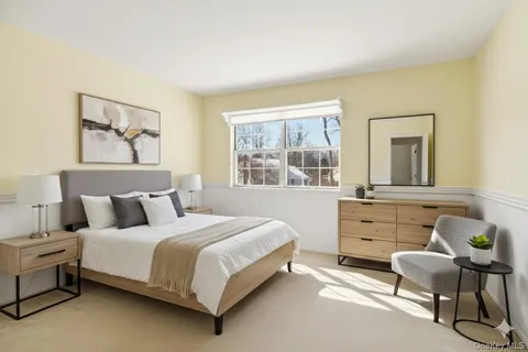 a bedroom with a bed and a table chair