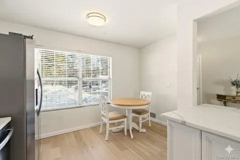 a view of a room with a chandelier and wooden floor