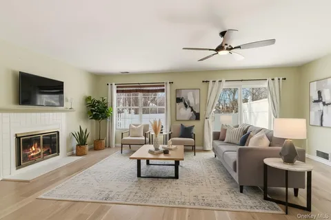 a view of livingroom with window fireplace and wooden floor