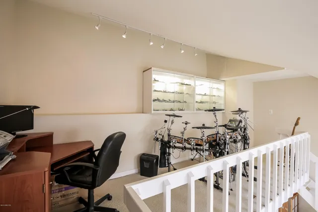a view of a workspace with furniture and a window