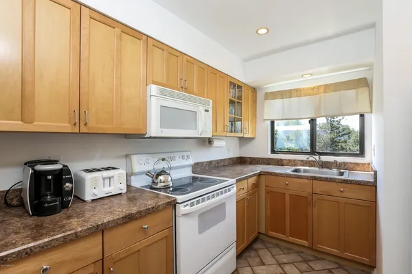 a kitchen with a sink cabinets and window