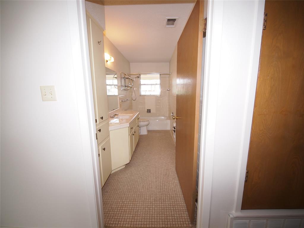 1441 Brazos Street Graham, TX 76450 - Photo 13 of 34 a bathroom with a sink and mirror