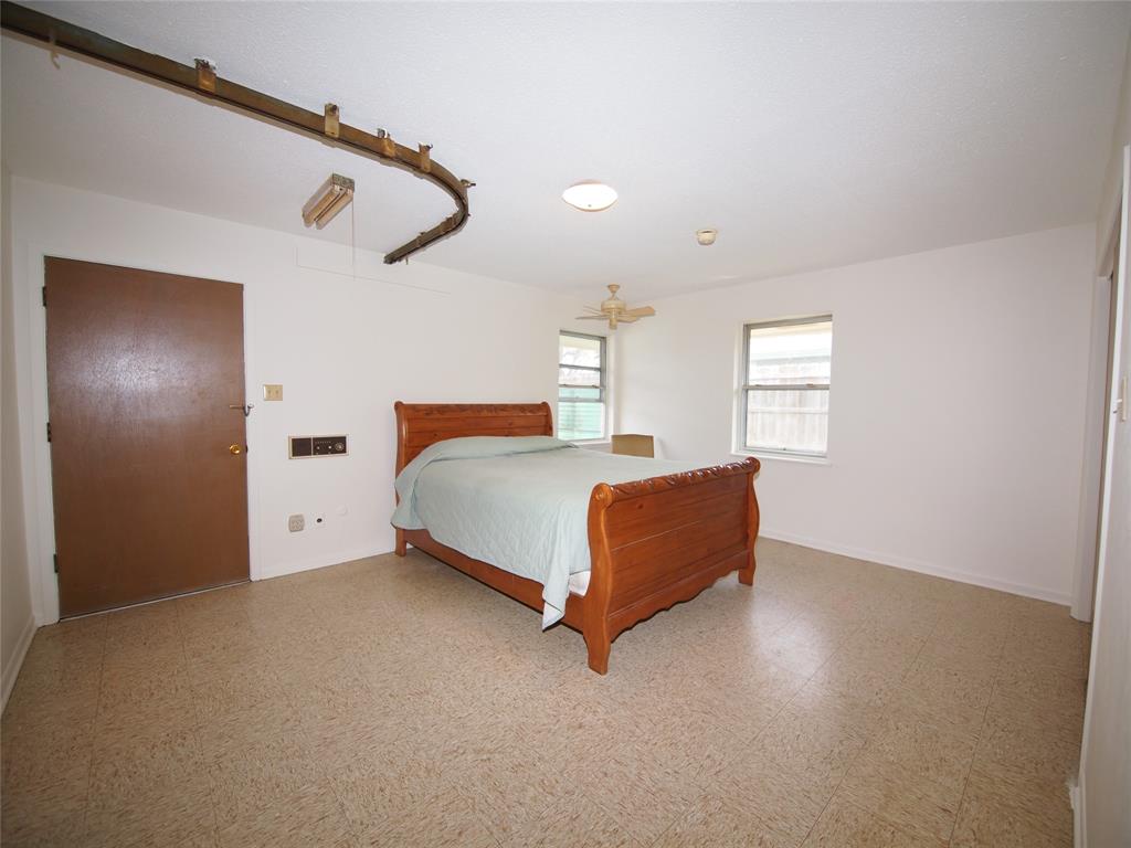 1441 Brazos Street Graham, TX 76450 - Photo 17 of 34 a bedroom with a bed and window