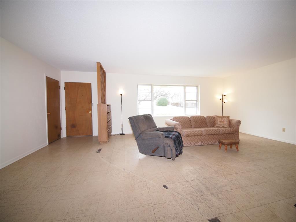 1441 Brazos Street Graham, TX 76450 - Photo 2 of 34 a living room with furniture and a large window