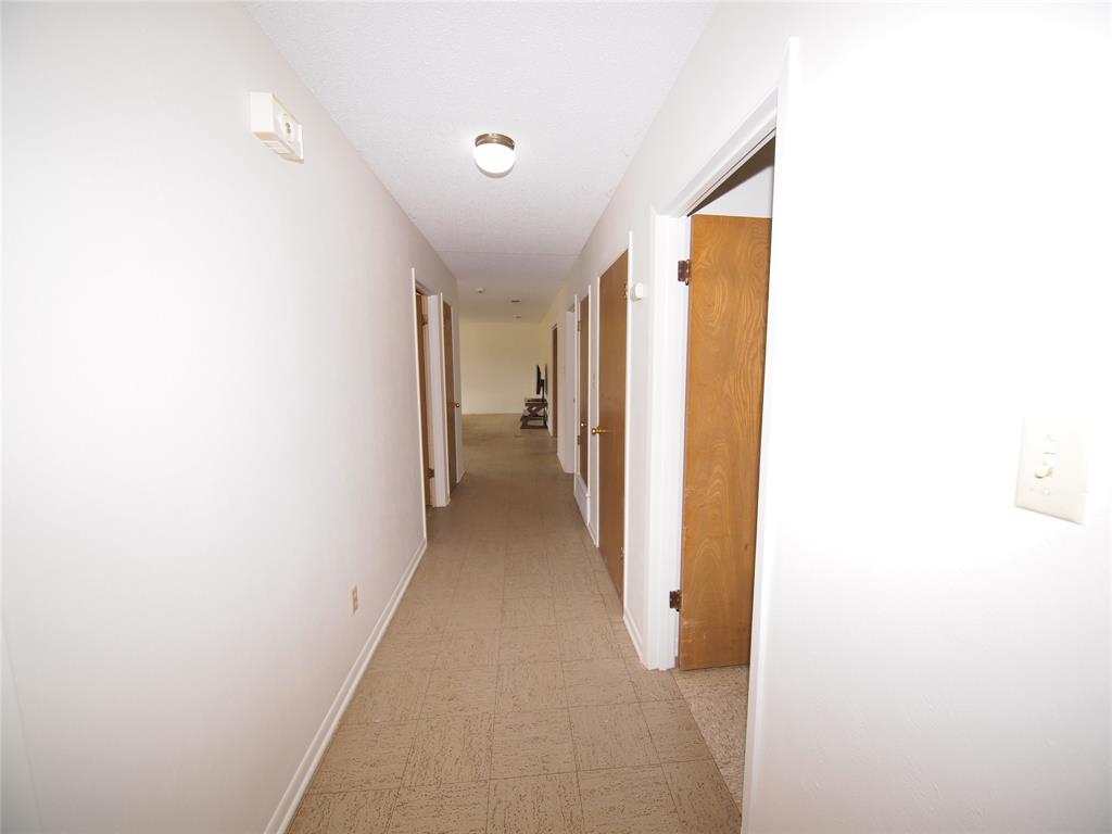 1441 Brazos Street Graham, TX 76450 - Photo 23 of 34 a view of a hallway with a bathroom