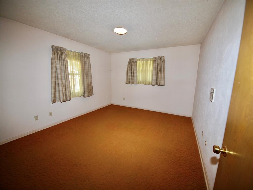 1441 Brazos Street Graham, TX 76450 - Photo 25 of 34 an empty room with windows