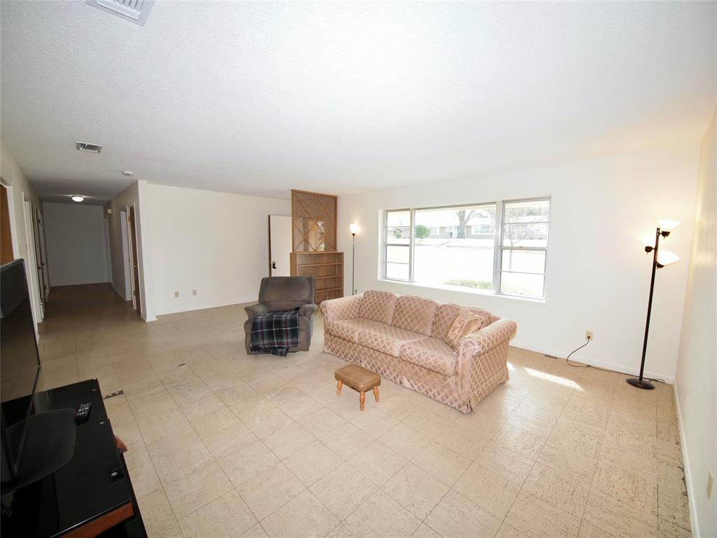 1441 Brazos Street Graham, TX 76450 - Photo 3 of 34 a living room with furniture and a window