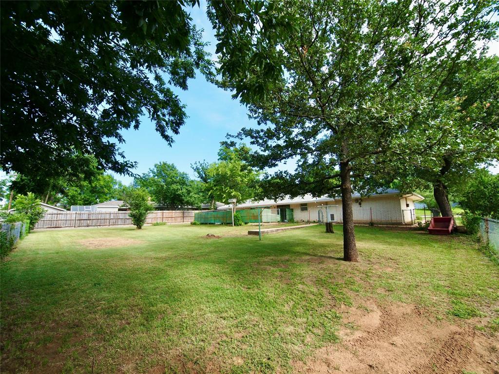 1441 Brazos Street Graham, TX 76450 - Photo 31 of 34 a view of a yard with a house