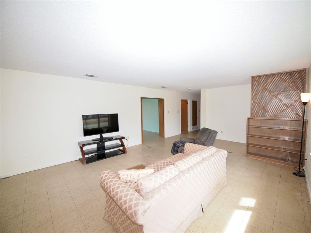 1441 Brazos Street Graham, TX 76450 - Photo 4 of 34 a bedroom with a bed and flat screen tv