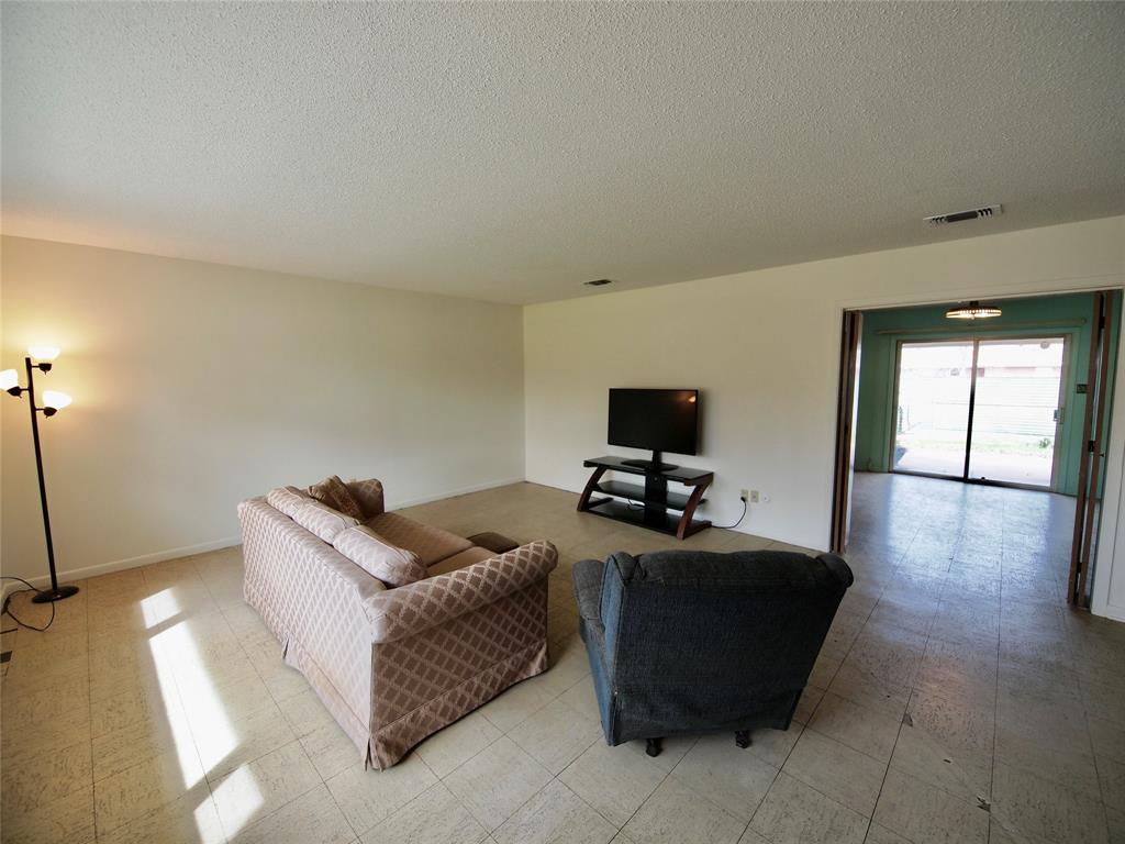 1441 Brazos Street Graham, TX 76450 - Photo 5 of 34 a living room with furniture and a flat screen tv