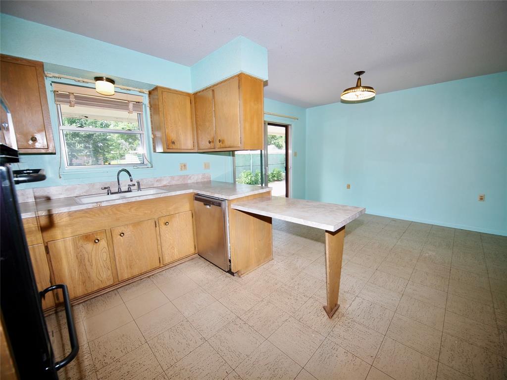 1441 Brazos Street Graham, TX 76450 - Photo 10 of 34 a kitchen with a sink cabinets and window