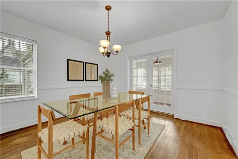 a view of a dining room with furniture and chandelier