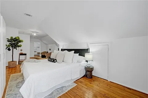 a bed room with a bed and a potted plant