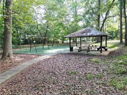 a view of a house with backyard and trees