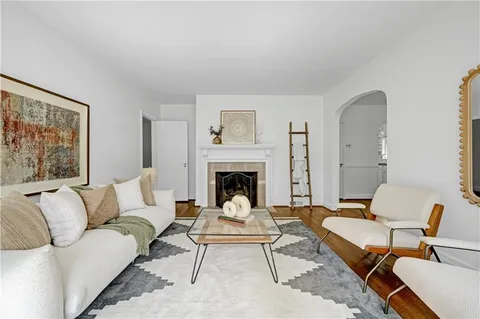 a living room with furniture two couches and a fireplace