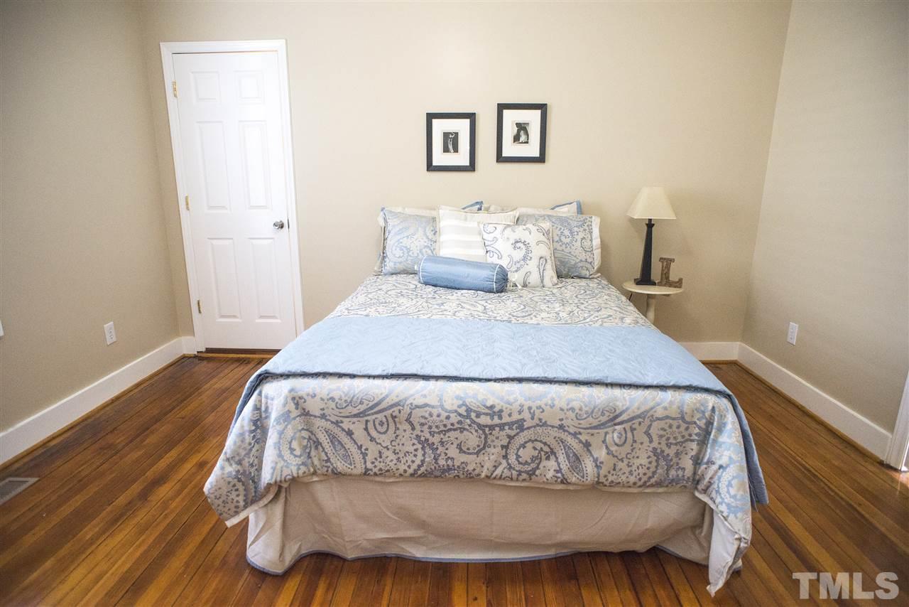 702 East Edenton Street Raleigh, NC 27601 - Photo 11 of 19 a bedroom with a bed and painting on the wall
