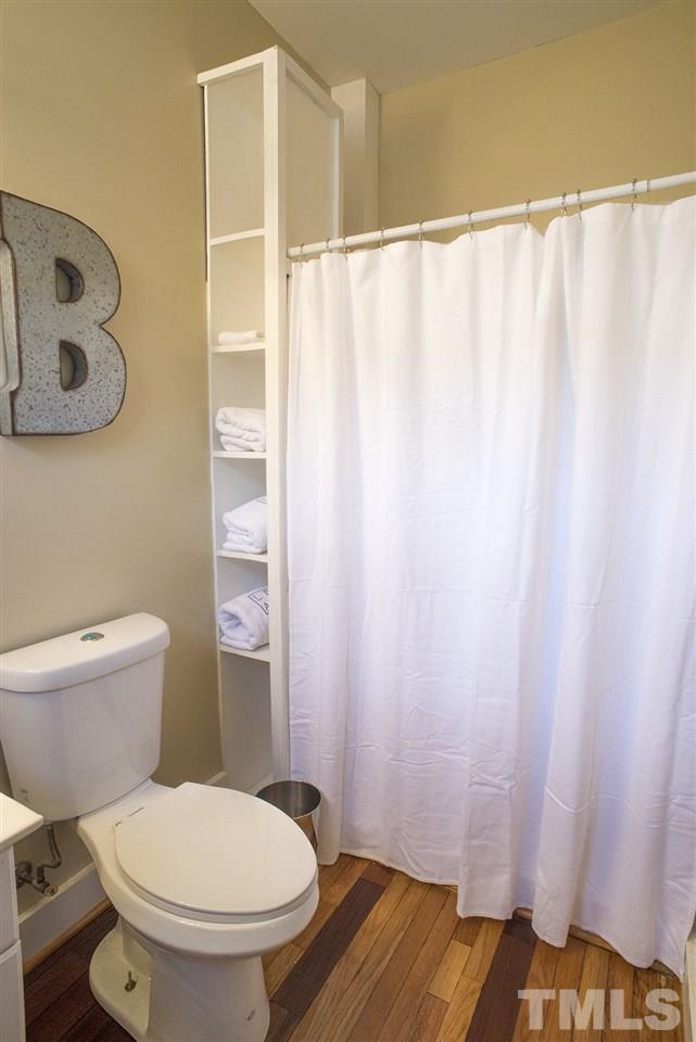 702 East Edenton Street Raleigh, NC 27601 - Photo 12 of 19 a white toilet sitting next to a shower curtain