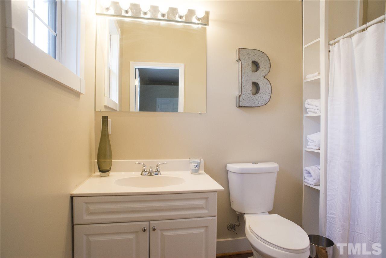 702 East Edenton Street Raleigh, NC 27601 - Photo 13 of 19 a bathroom with a sink a toilet and mirror