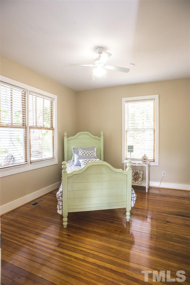702 East Edenton Street Raleigh, NC 27601 - Photo 14 of 19 a spacious bedroom with a bed and wooden floor