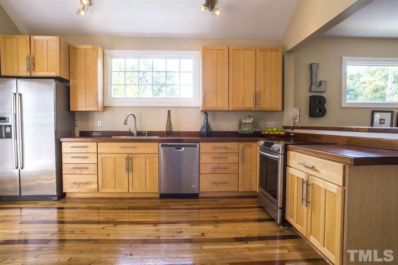 702 East Edenton Street Raleigh, NC 27601 - Photo 4 of 19 a kitchen with stainless steel appliances granite countertop a sink stove a refrigerator a sink and dishwasher with wooden floor