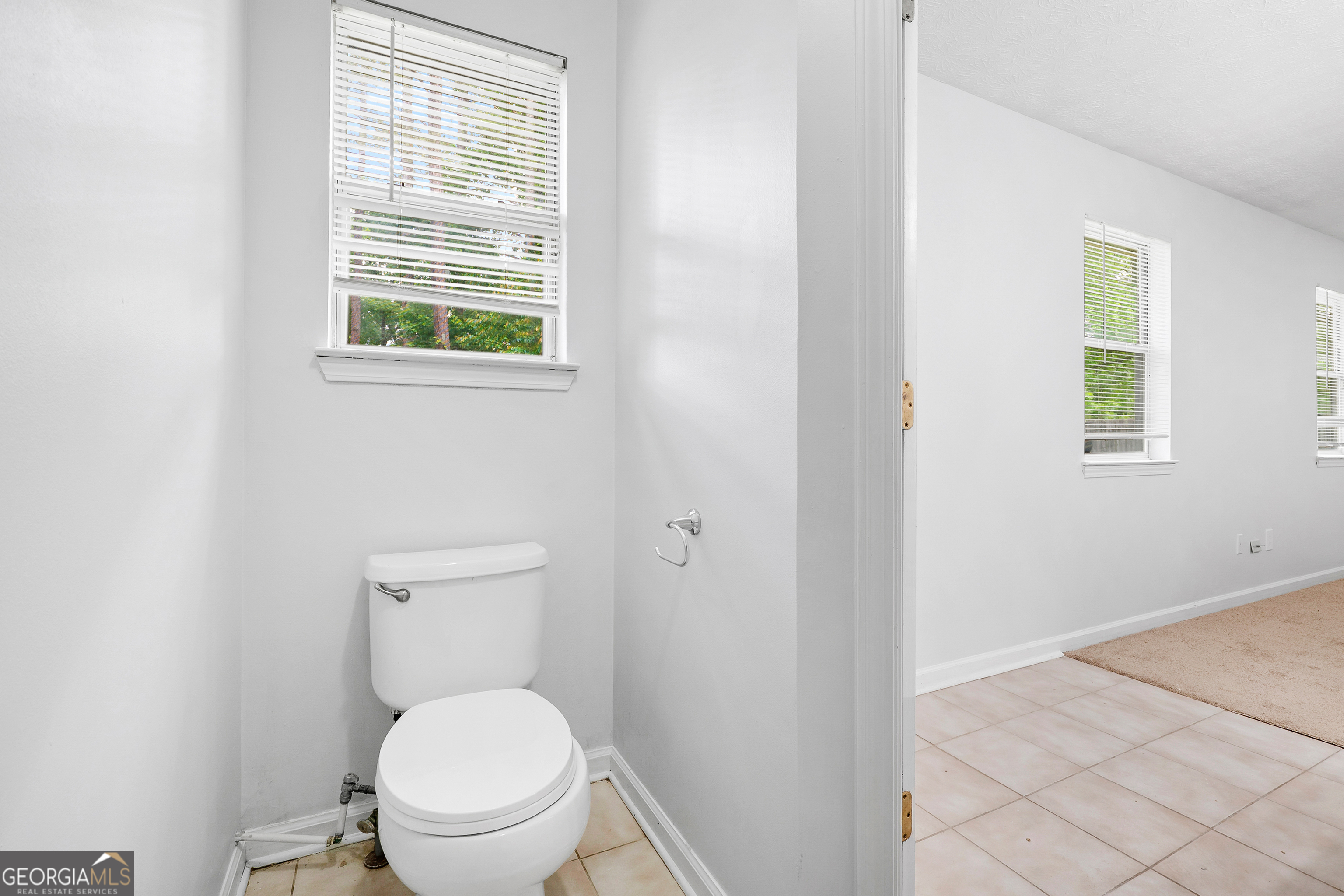 1328 Foxvale Drive Hampton, GA 30228 - Photo 17 of 27 a white toilet sitting next to a window