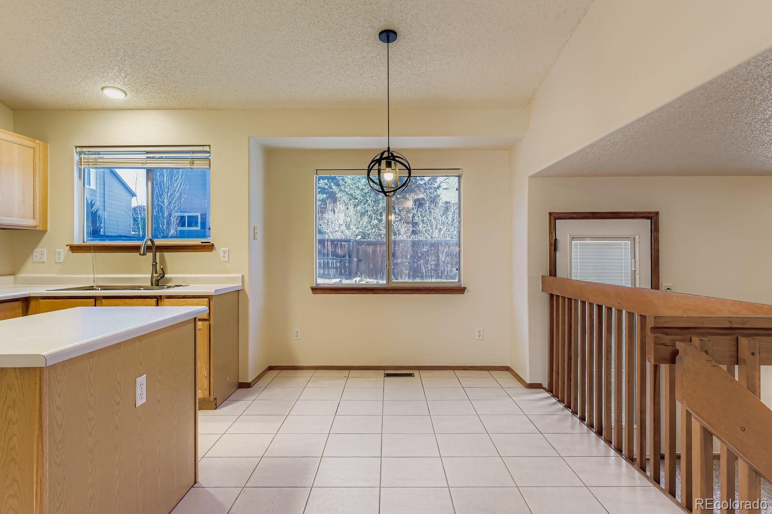 10505 Hyacinth Place Highlands Ranch, CO 80129 - Photo 13 of 40 a view of a kitchen with a sink cabinets and window