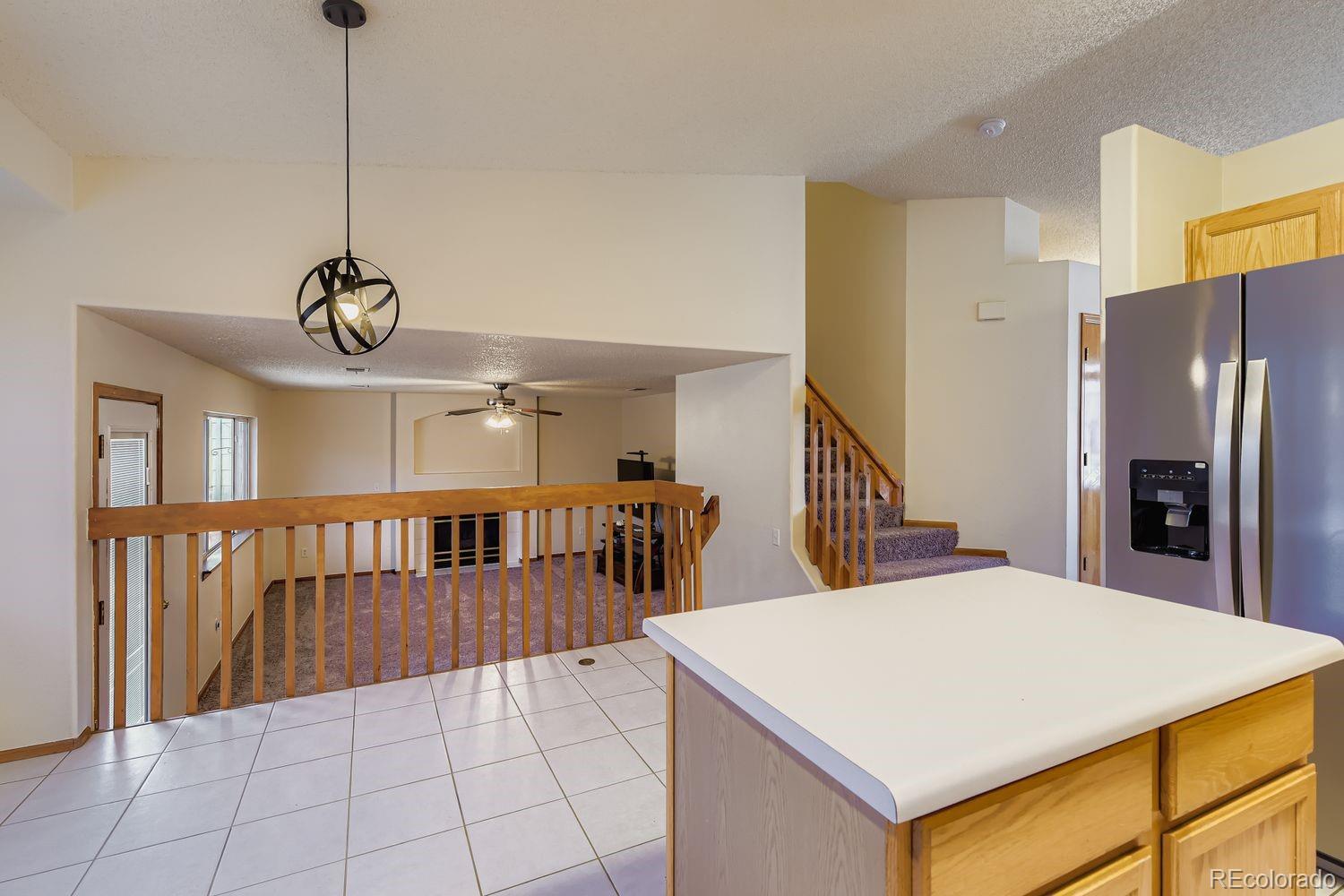 10505 Hyacinth Place Highlands Ranch, CO 80129 - Photo 14 of 40 a view of a room with furniture and kitchen view