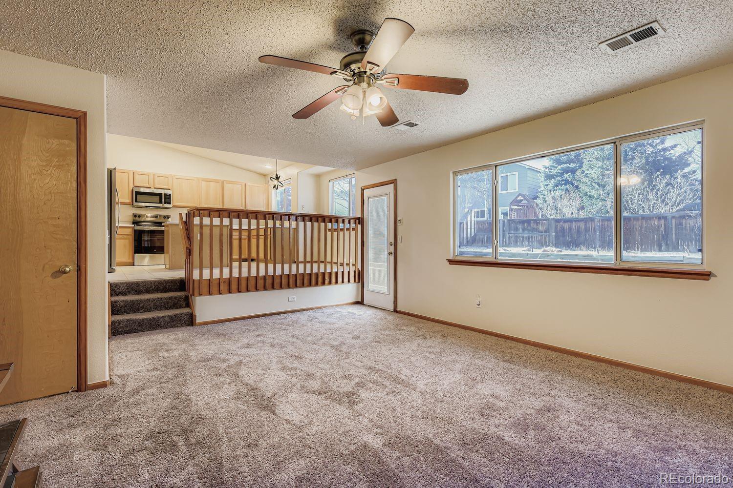 10505 Hyacinth Place Highlands Ranch, CO 80129 - Photo 17 of 40 a view of entryway and hall with a chandelier fan