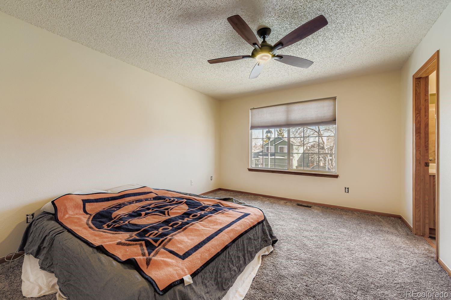 10505 Hyacinth Place Highlands Ranch, CO 80129 - Photo 19 of 40 a bed sitting in a room next to a window