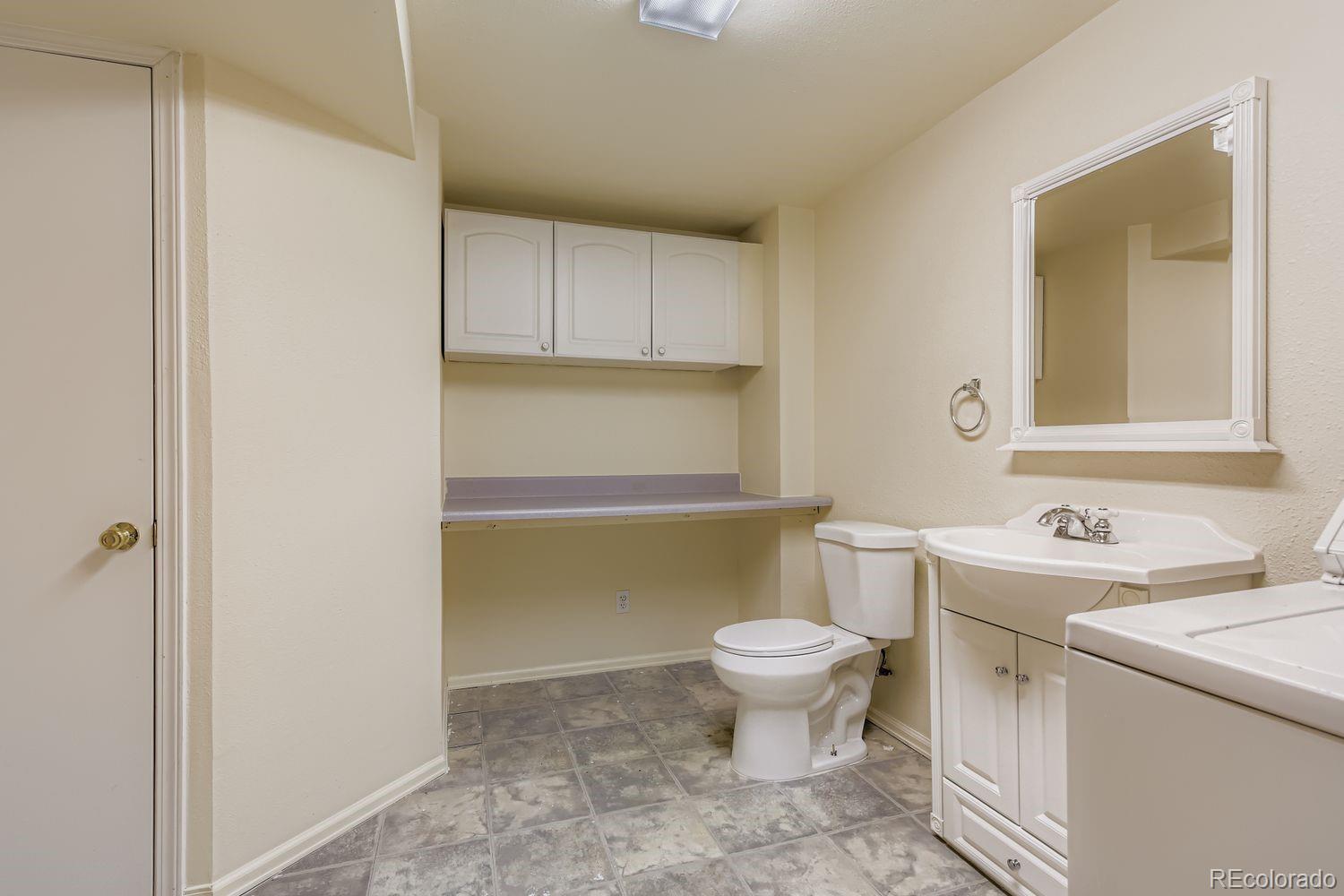 10505 Hyacinth Place Highlands Ranch, CO 80129 - Photo 30 of 40 a bathroom with a sink toilet and mirror