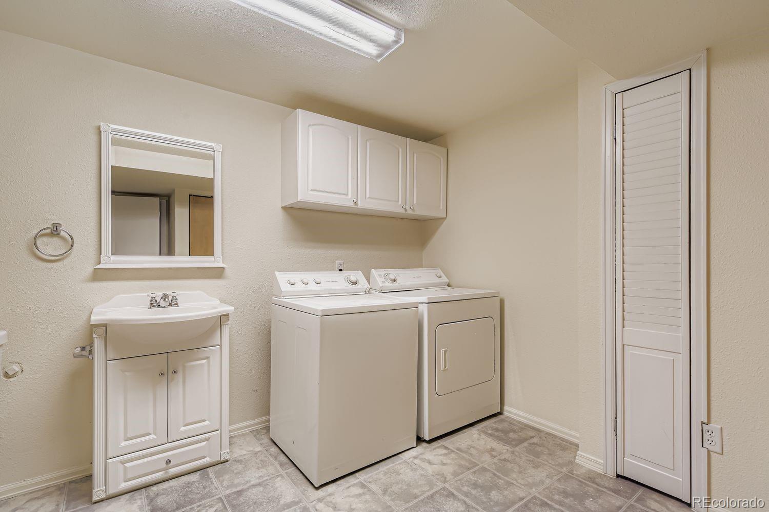 10505 Hyacinth Place Highlands Ranch, CO 80129 - Photo 31 of 40 a utility room with dryer and washer