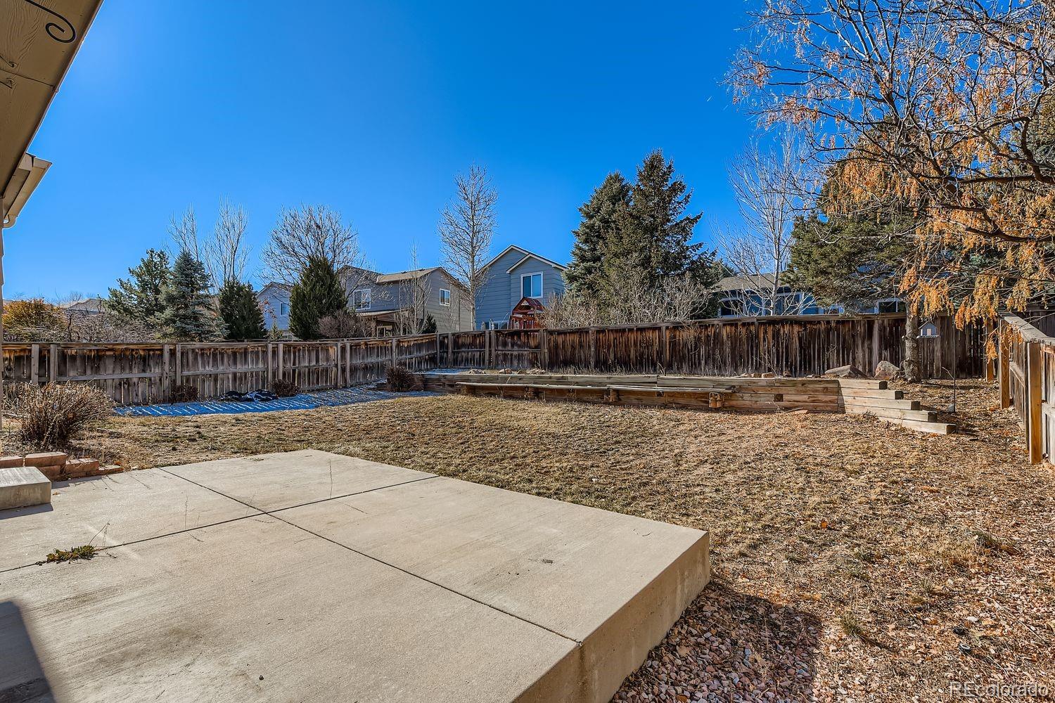 10505 Hyacinth Place Highlands Ranch, CO 80129 - Photo 32 of 40 a view of a yard with wooden fence