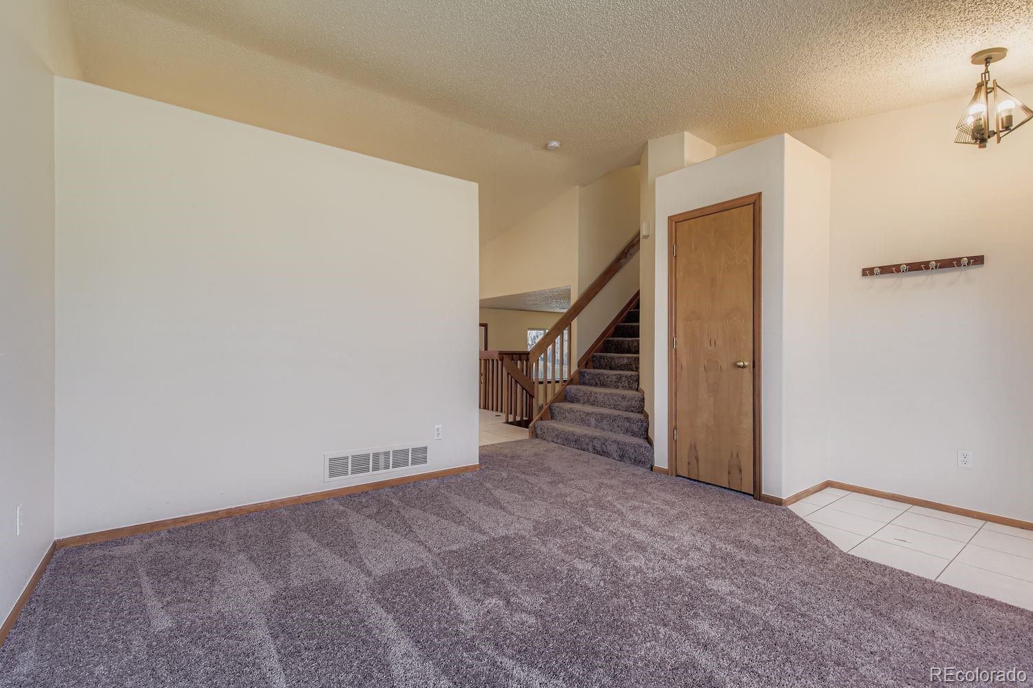 10505 Hyacinth Place Highlands Ranch, CO 80129 - Photo 6 of 40 a view of an empty room with stairs