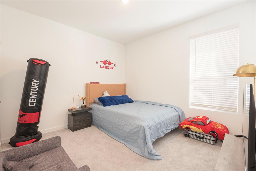512 Capstone Court Princeton, TX 75407 - Photo 13 of 32 a bedroom with bed and window