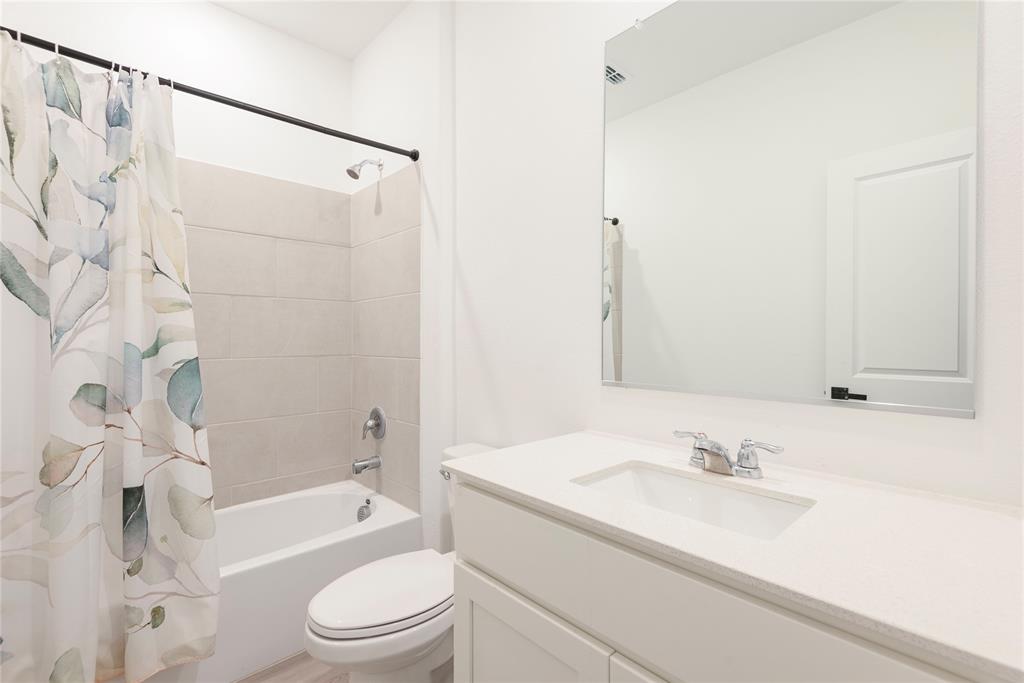 512 Capstone Court Princeton, TX 75407 - Photo 17 of 32 a bathroom with a sink toilet vanity and shower