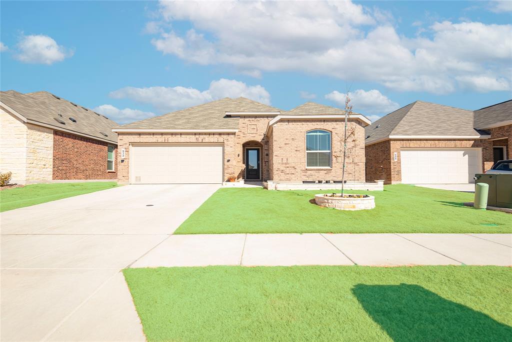 512 Capstone Court Princeton, TX 75407 - Photo 3 of 32 a front view of a house with a garden and yard